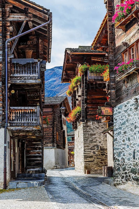Wooden houses decorated with flowers in the historic village centre, Grimentz, Val d'Anniviers, Valais Alps, Canton Valais, Switzerland