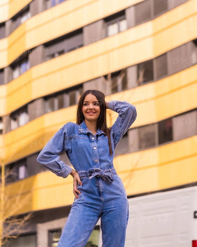 Young caucasian girl with a monkey cowboy in a yellow and black house. Enjoying the city on vacation, a young girl lifestyle, in a trendy posing smiling