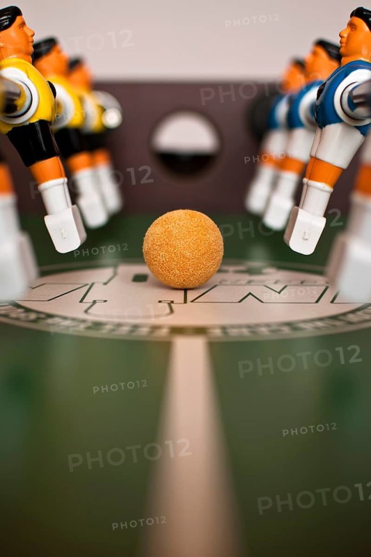 Foosball table close-up of the ball and players in Poland