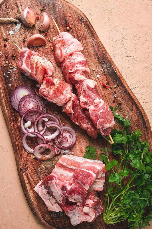 Raw pork meat, on wooden sticks, pickled kebab, with spices, top view, no people