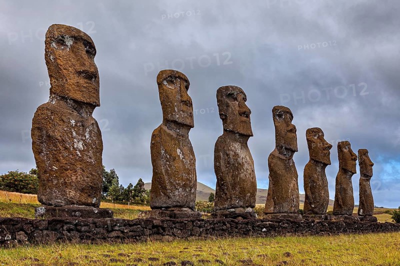 Moai statues on Easter Island rising out of a grassland into the cloudy sky, The Moai statues on Easter Island in the Pacific Ocean