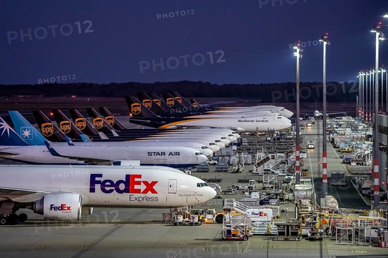 Cologne-Bonn airport, CGN, air freight center, UPS Logisic Hub, UPS cargo aircraft on the apron, FedEx and Star Air Cargo aircraft, Maersk, at the logistics center, in the evening