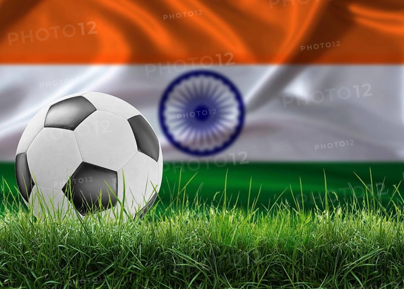 Soccer ball on pitch against Indian flag background. Soccer ball on the grass with India flag in the background