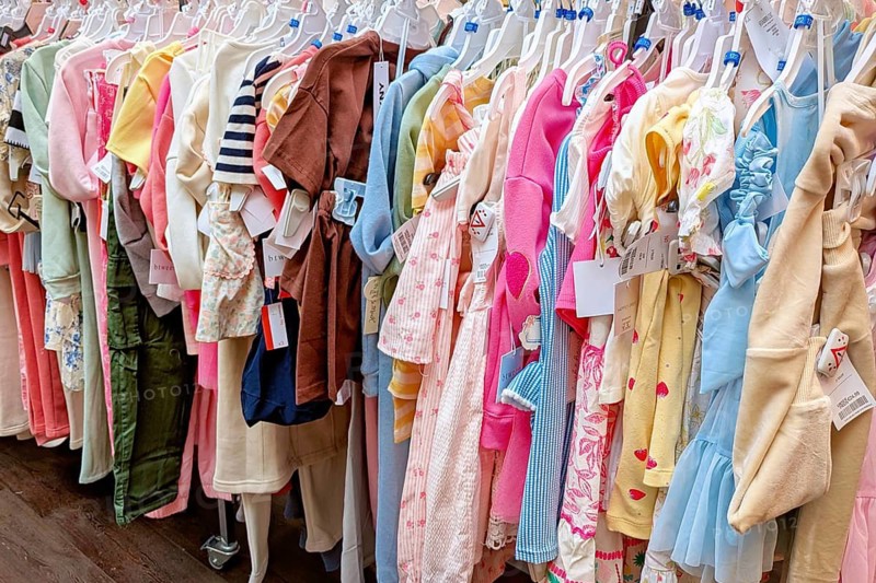 Heidelberg, Germany - April 7th 2026: Clothing rack with children's clothes for young kids, mostly girls' fashion in various colors displayed in a retail store