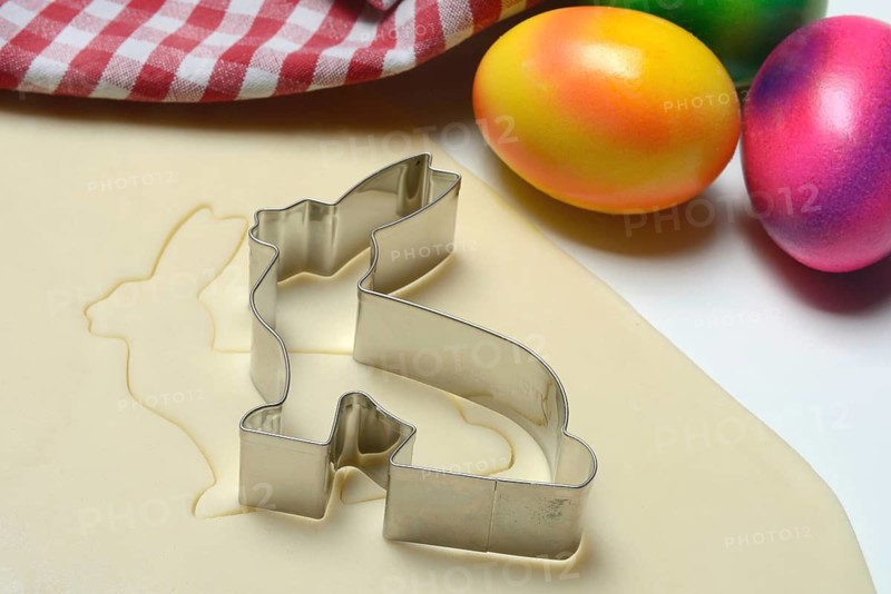 Rolled dough with bunny cookie cutter and easter eggs
