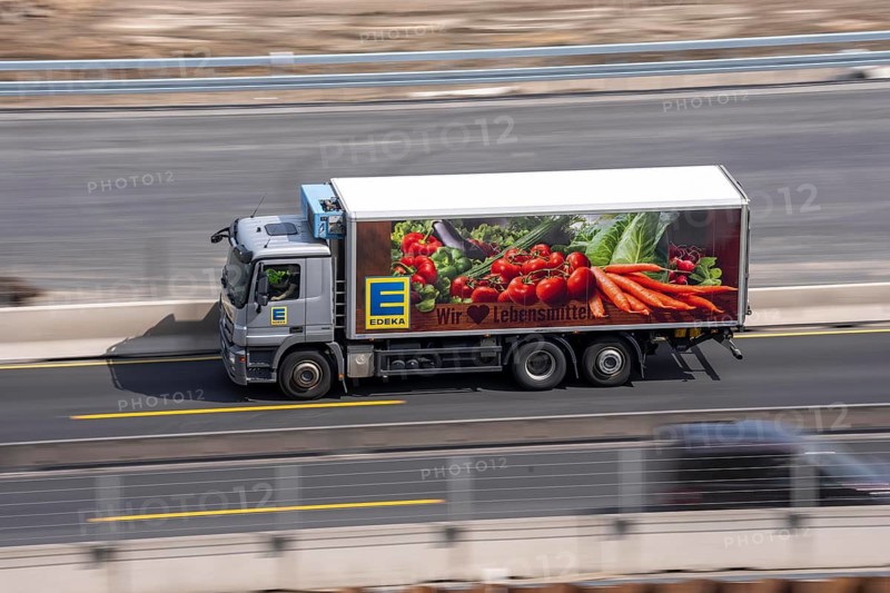 Freight truck for food logistics, on the motorway, supermarket chain EDEKA