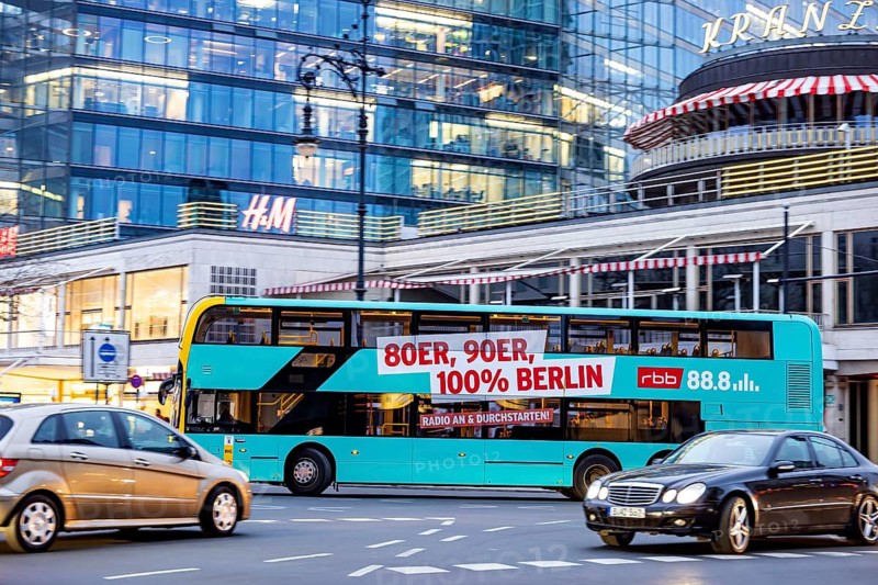 Double-decker bus on Kurfürstendamm. City view of Berlin. BVG public bus with advertising for music from the 1980s on RBB. Berlin, Germany