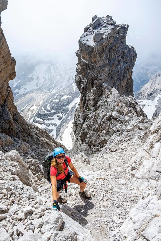 Female hiker climbs the Cima falconer mountain peak, Brenta Mountains, Brenta, Brenta-Adamello Natural Park, Trentino, Italy