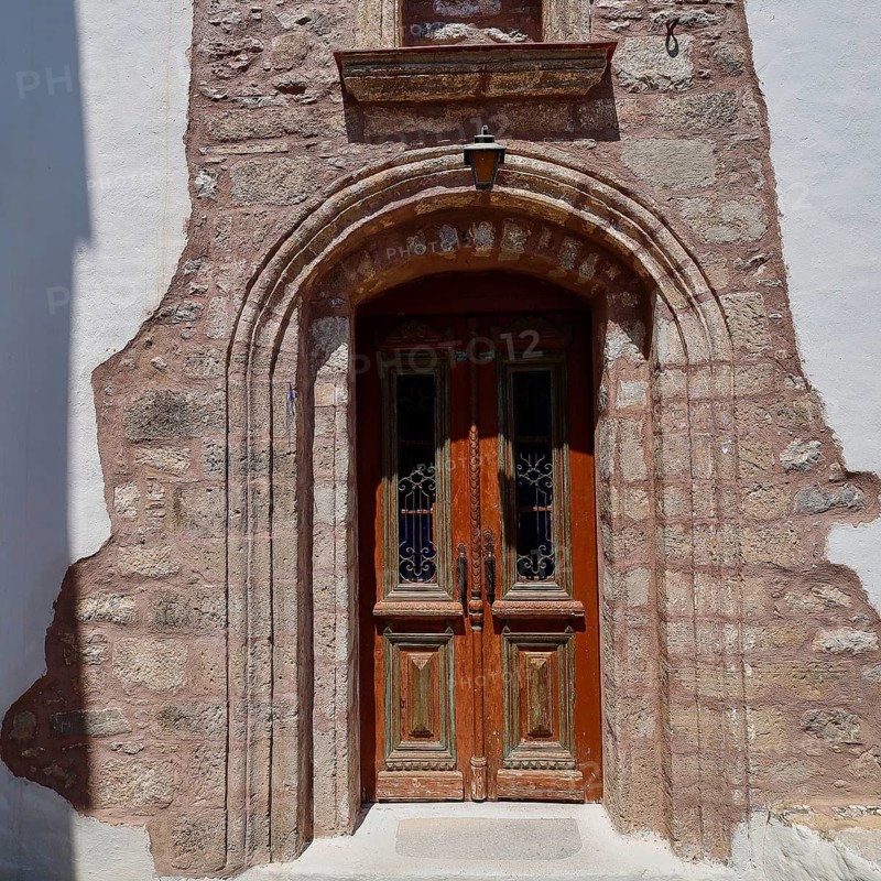 Taxiarchis, Church of the Archangel, rustic wooden door in stone arch as the entrance to a historic building, Megalo Chorio, Zero Waste Island, Tilos, Dodecanese, Greek Islands, Greece