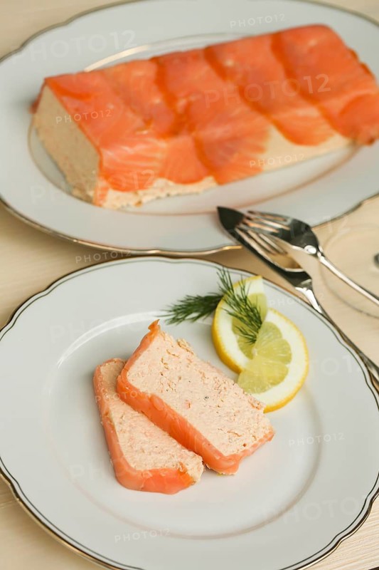 Southern German cuisine, salmon trout terrine arranged on a plate, salmon terrine with trout fillets, fish dish, salmon fillets, smoked salmon, starter, fine dining, Sunday crockery with gold rim, grandma's service, lemons, dill, fish cutlery, food photography, studio, Germany
