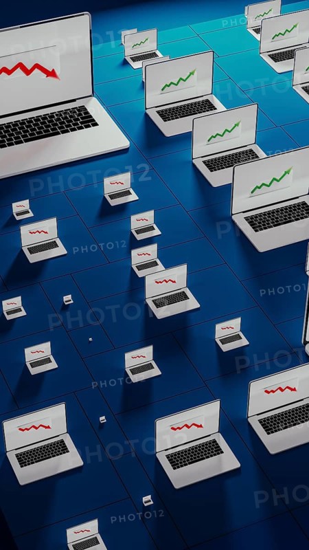 Laptops in a modern office show fluctuating stock trends, reflecting the dynamic nature of financial activities
