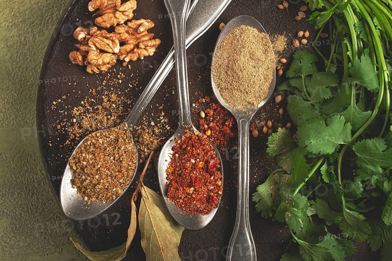 Georgian spices in spoons, on ketsi, top view, no people