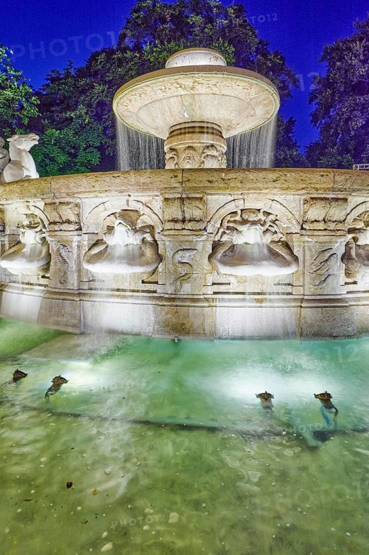 Wittelsbach fountain, cascade fountain, neoclassical art movement, sculptor Adolf von Hildebrand, trees, image processing brightnesses and contrasts, deep blue evening sky, cloudless, Maximiliansplatz, Munich, state capital, district-free city, Bavaria, Germany