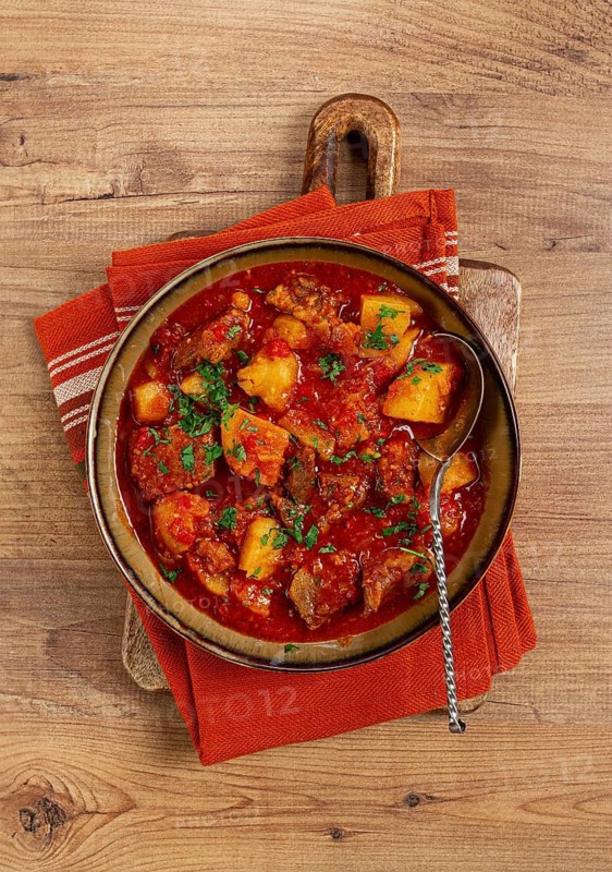 Potatoes with meat, stewed in tomato sauce, with spices and herbs, homemade, no people
