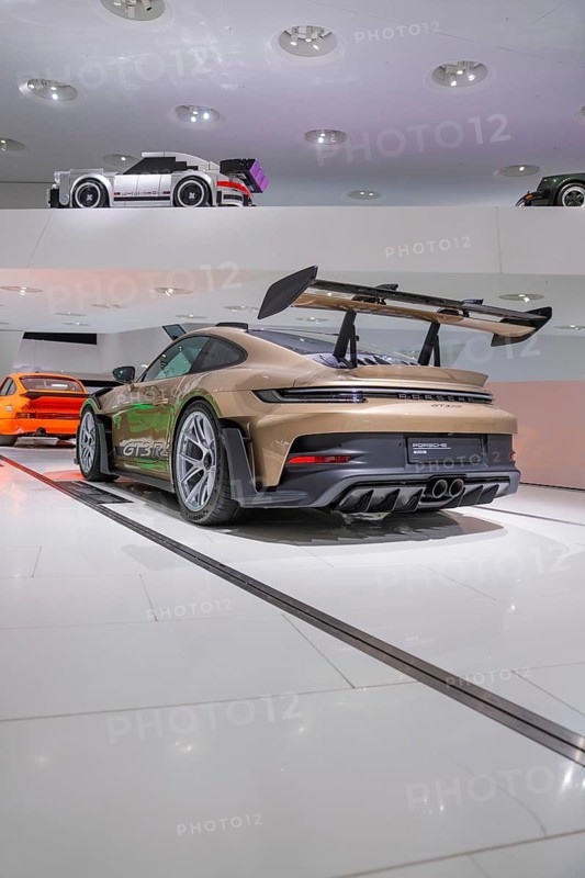 Modern GT3 sports car with large rear wing in an exhibition hall, Porsche Museum, Stuttgart, Germany