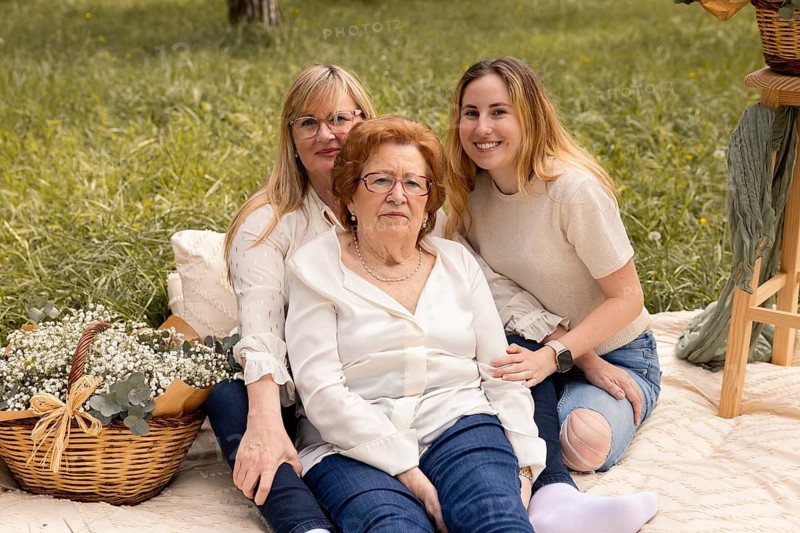 A heartwarming image featuring three generations of women, grandmother, mother, and daughter enjoying a serene day outdoors, epitomizing family ties and shared moments