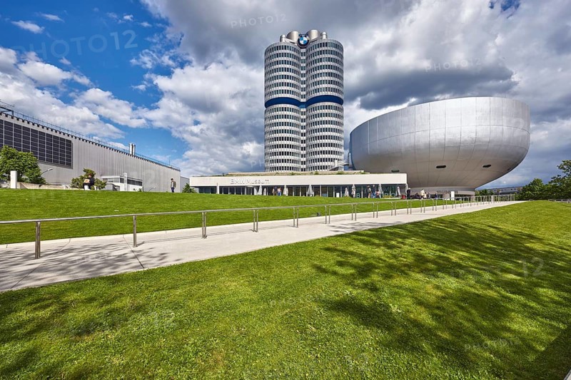 BMW museum, car museum, BMW corporate headquarters, high-rise building, modern architecture, commercial building, architect Karl Schwanzer, BMW four-cylinder, BMW tower, BMW high-rise building, sidewalk, metal railing, meadow, trees, blue sky, white and dark gray cumulus clouds, Am Olympiapark, Munich, state capital, district-free city, Bavaria, Germany