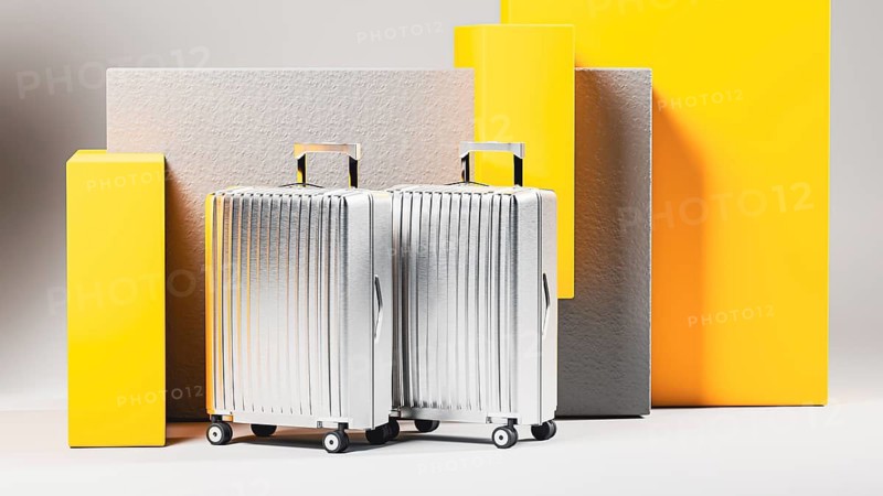 A collection of shining suitcases stands against a neutral backdrop, inviting thoughts of new adventures and exciting journeys to distant places