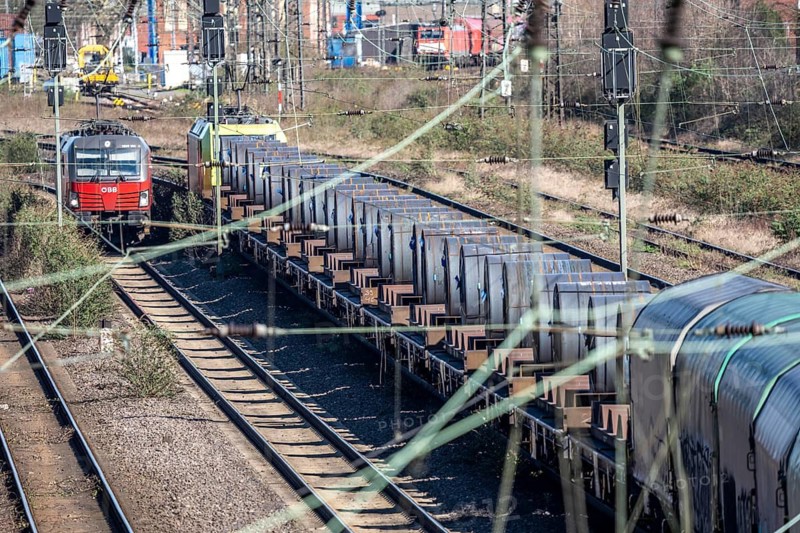 Freight train on the line in front of the Oberhausen-Osterfeld marshalling yard, loaded with steel coils, rolled up strip steel for further processing, from the ThyssenKrupp steel plant in Duisburg, North Rhine-Westphalia, Germany