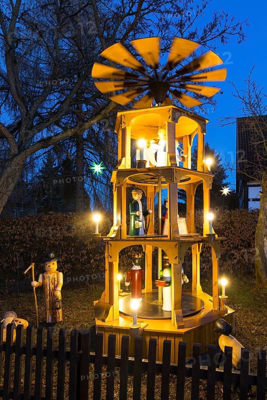 Christmas pyramid with wooden figures in the village of Unkersdorf in the evening, Dresden, Saxony, Germany