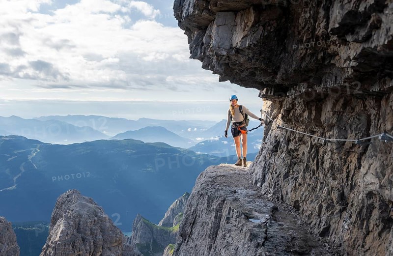 Climbers on a rock band, Bocchette Centrale band trail, via ferrata in the Brenta Mountains, Brenta-Adamello Natural Park, Trentino, Italy