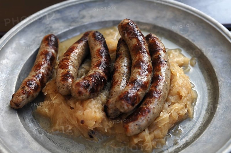Six Nuremberg bratwurst with cabbage served on a tin plate, Nuremberg, Middle Franconia, Bavaria, Germany