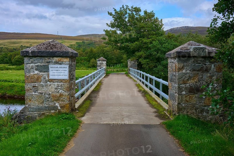 Stone bridge in picturesque landscape with river and trees, cloudy sky, Sutherland, Strathnaver, Kinbrace, Scotland, United Kingdom, Great Britain