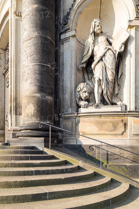 Sandstone figure of St Mark the Apostle with a lion on the outer façade of the Hofkirche, Dresden, Saxony, Germany