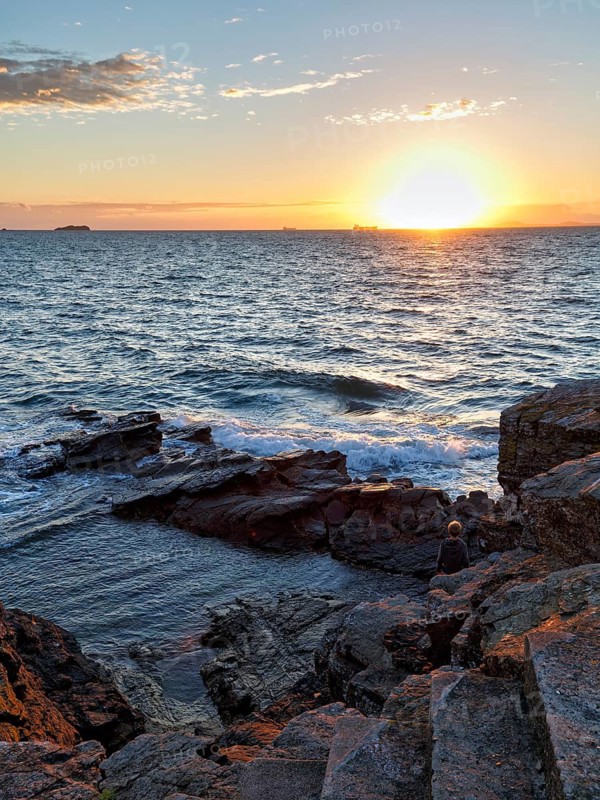 Sunset at the sea, rocky coast, container ships on the horizon, backlight, Little Haven, Pembrokeshire Coast National Park, Wales, Great Britain