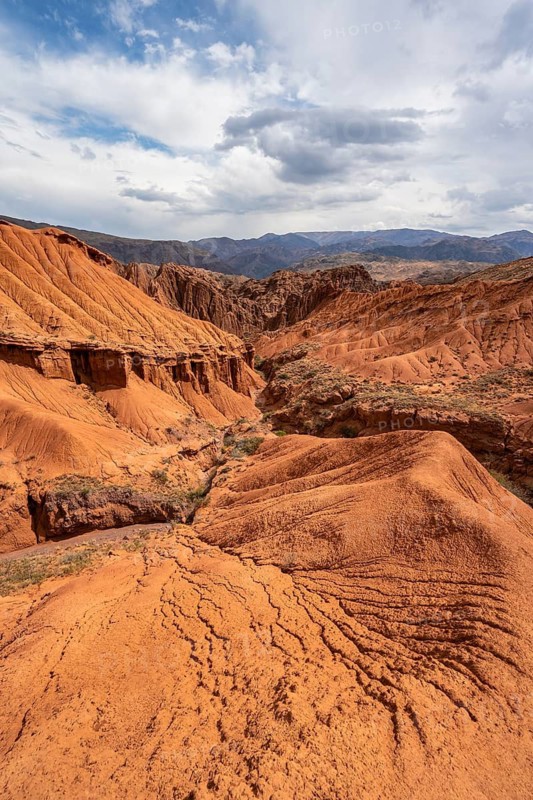 View of eroded mountain landscape with sandstone cliffs, canyon with red and orange rock formations, Konorchek Canyon, Chuy, Kyrgyzstan
