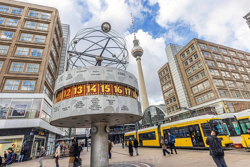 View of Alexanderplatz in Berlin. Landmark world clock and a tram. TV tower. Berlin, Germany