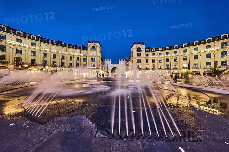 Square, historic commercial building, Karlsplatz roundel, neo-Baroque style, architects Gabriel von Seidl and Oscar Strelin, Osram neon sign, bright as light day, fountain, image processing brightnesses and contrasts, evening blue hour, deep blue evening sky, cloudless, Stachus, Karlsplatz, Munich, state capital, district-free city, Bavaria, Germany