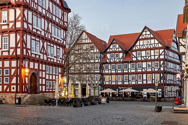 Charming half-timbered houses and illuminated café at dusk, the old town centre of Melsungen