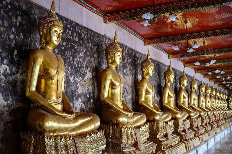 Bangkok, Thailand. February 20th 2025. A row of Golden Buddhist statues in a pavilion at the The Wat Suthat Thepwararam