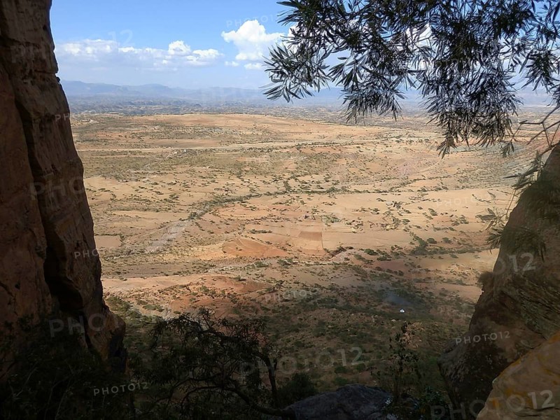 View from Abuna Yemata Guh rock church through trees to a wide valley and distant mountains, Tigray, Ethiopia