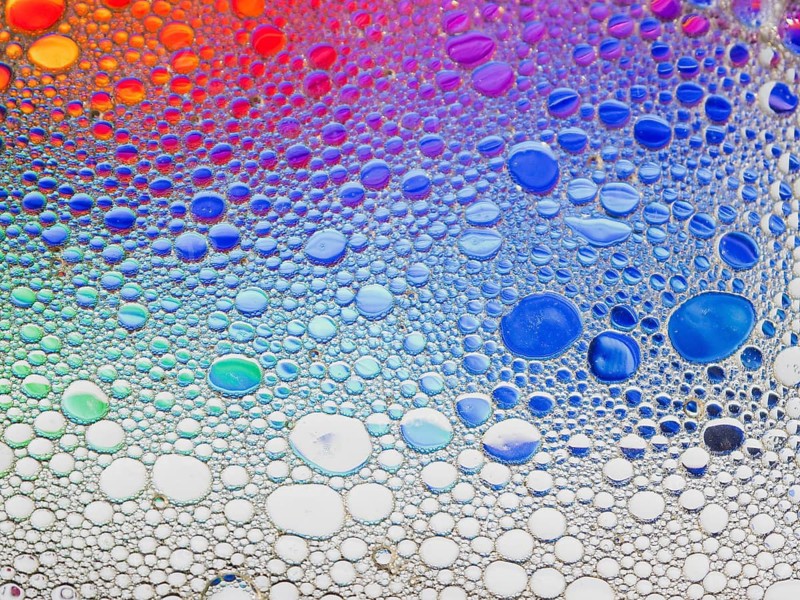 An abstract image featuring a vibrant array of colorful bubbles. The gradient transitions smoothly through multiple colors, creating a dynamic visual experience