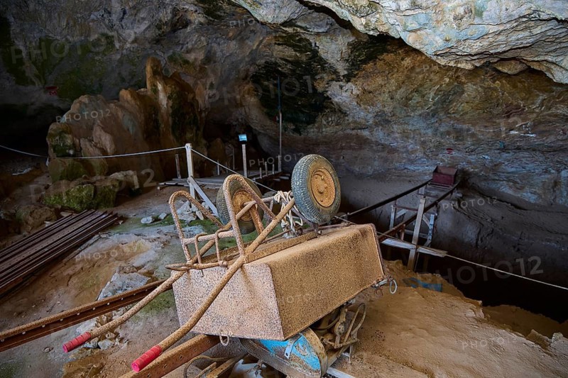 Rusty excavation cart standing in a cave on wooden platforms, museum, Charkadio Cave, dwarf elephant (Palaeolodoxon tiliensis), Elephas Tiliensis, Megalo Chorio, Zero Waste Island, Tilos, Dodecanese, Greek Islands, Greece