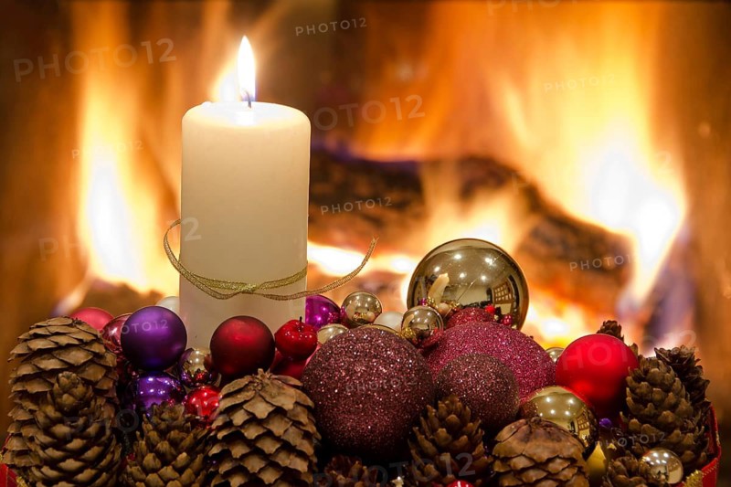 Christmas floral table decoration in front of the fireplace with candles