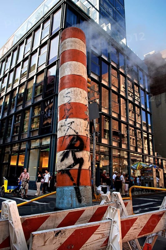 Steaming chimney at a construction site behind a high-rise building, New York City, USA