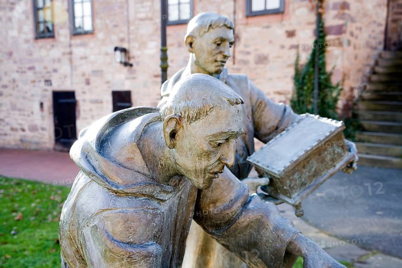 Sculpture, the monks Rogerus or Roger of Helmarshausen, well-known goldsmith with Herimann, creator of the Gospels of Henry the Lion, 12th century, Benedictine monastery, Helmarshausen, Bad Karlshafen, Hesse, Germany