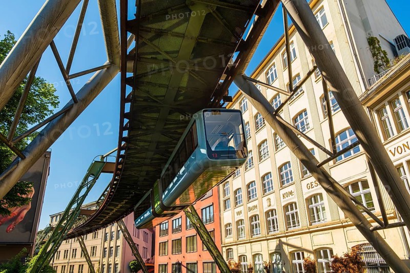 A suspension railway runs between old industrial buildings near the Kluse stop, Wuppertal, Germany