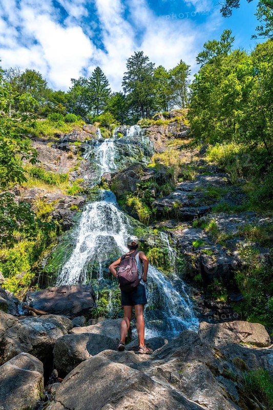 A hiker enjoying the summer at the Todtnau waterfall in the Black Forest in Germany