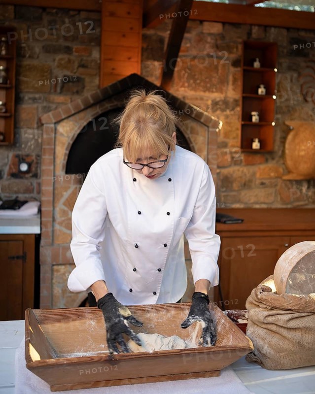 Greek woman baking Greek olive bread, Laconia, Peloponnese, Greece