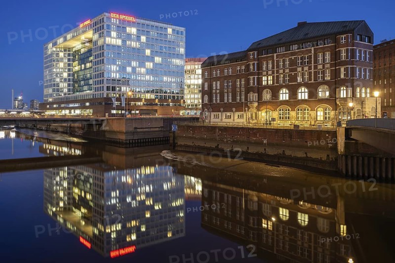 Modern mirror house and historic Ericus-Kontor at Ericusspitze at Blue Hour with reflection in the Fleet, Hamburg, Germany