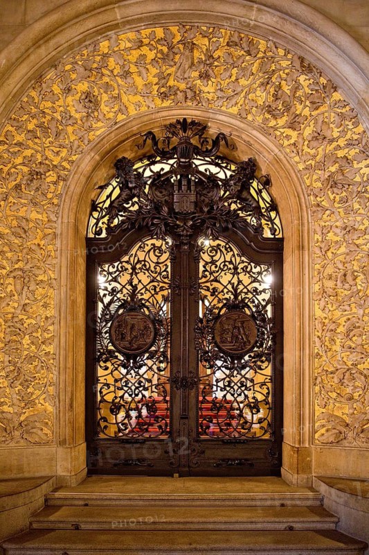 The golden-framed lattice gate to the Senate Staircase, City Hall, Hamburg, Germany