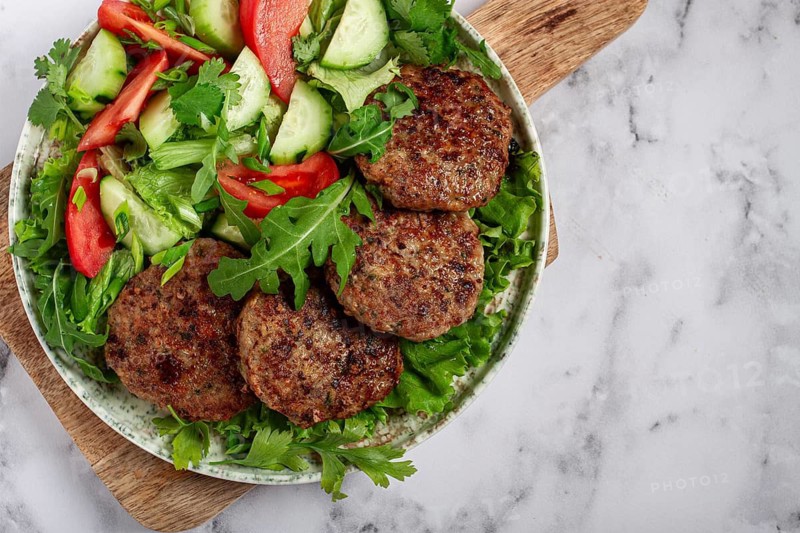 Fried cutlets, mixed minced meat, with vegetable salad, homemade, top view, no people