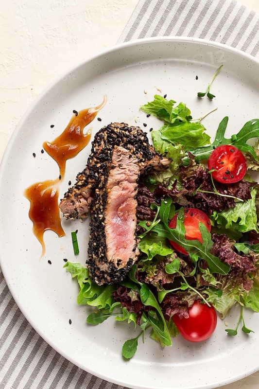 Vegetable salad, with fried tuna, in sesame seeds, healthy food, top view
