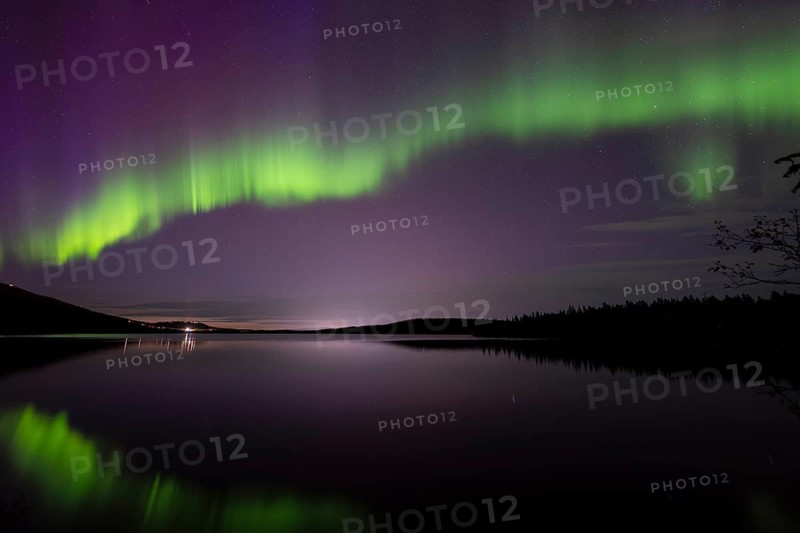 Northern Lights (Aurora borealis) reflected in a forest lake, Gällivare, Norrbotten, Lapland, Sweden, September 2023