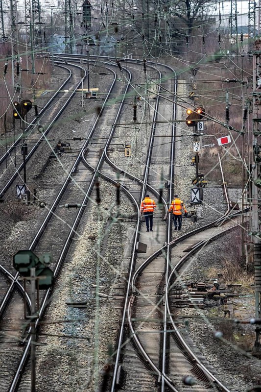 Railway employees check the tracks and switches at the Hagen-Vorhalle marshalling yard, is one of the 9 largest in Germany, it is located on the Wuppertal-Dortmund railway line and has 40 directional tracks on which freight trains of all types are assembled, North Rhine-Westphalia, Germany