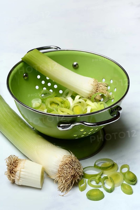 Leek, leek sticks and leek rings in a sieve bowl